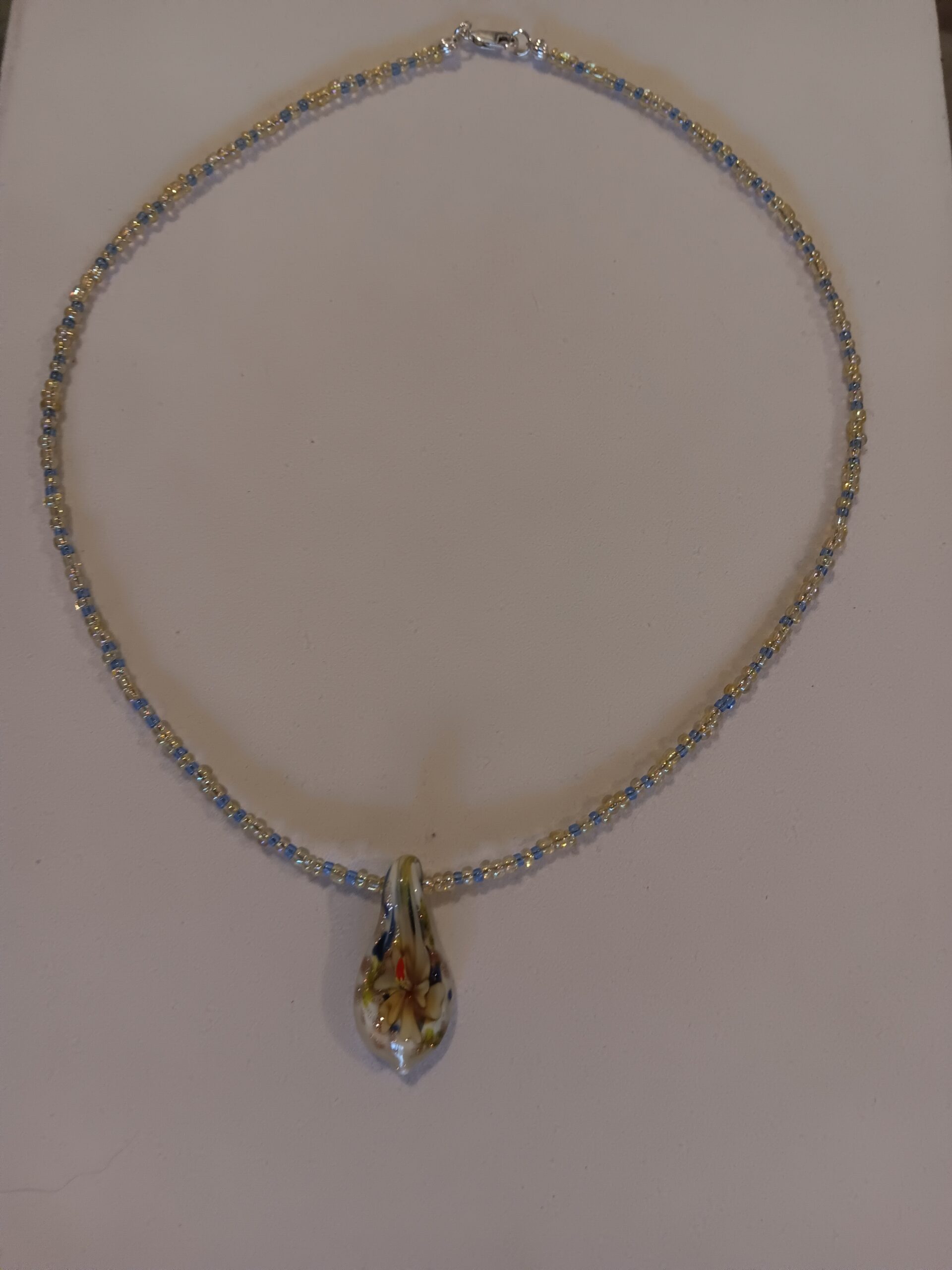 Yellow and blue necklace w/ intricate glass pendant
