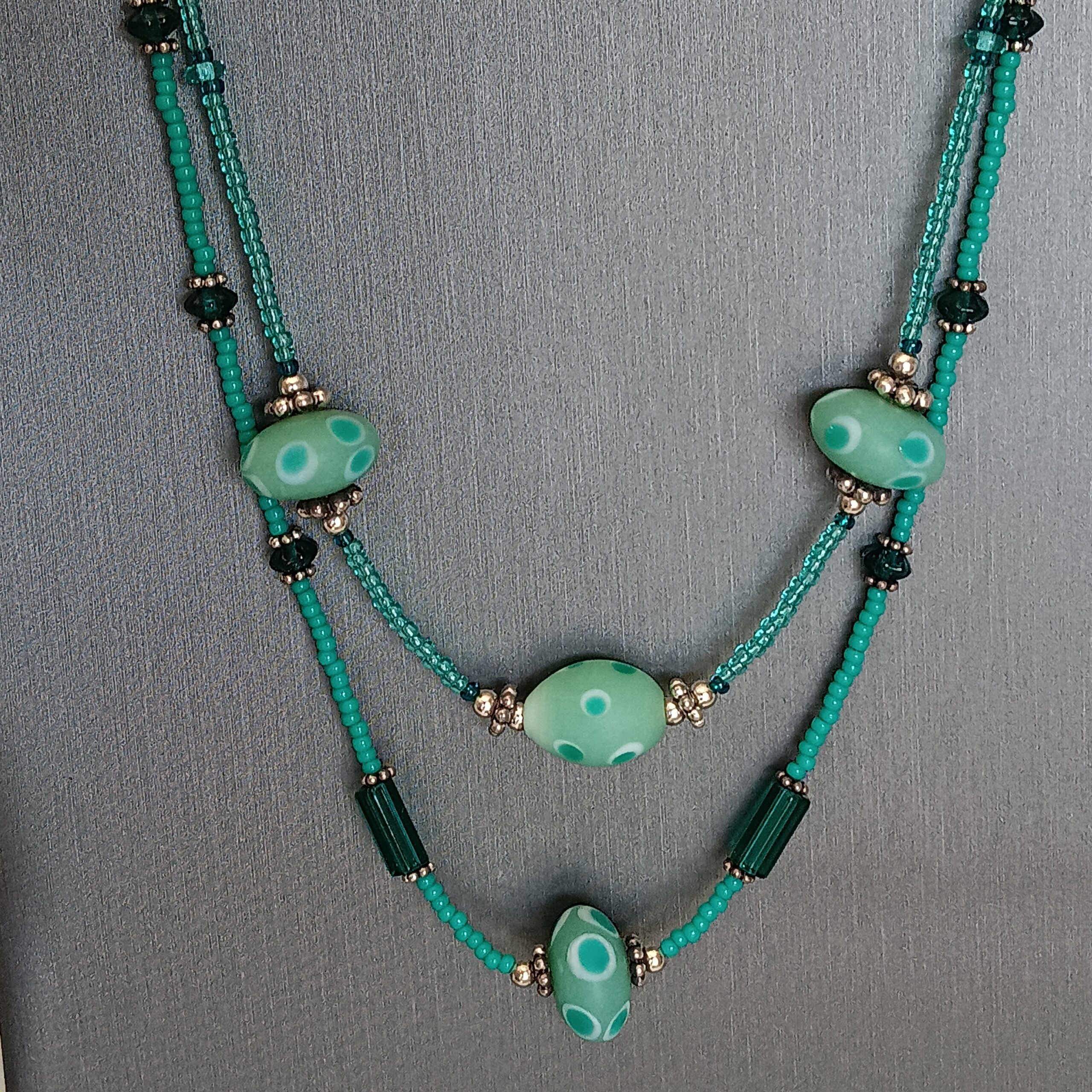 2 strands of various greens necklace.