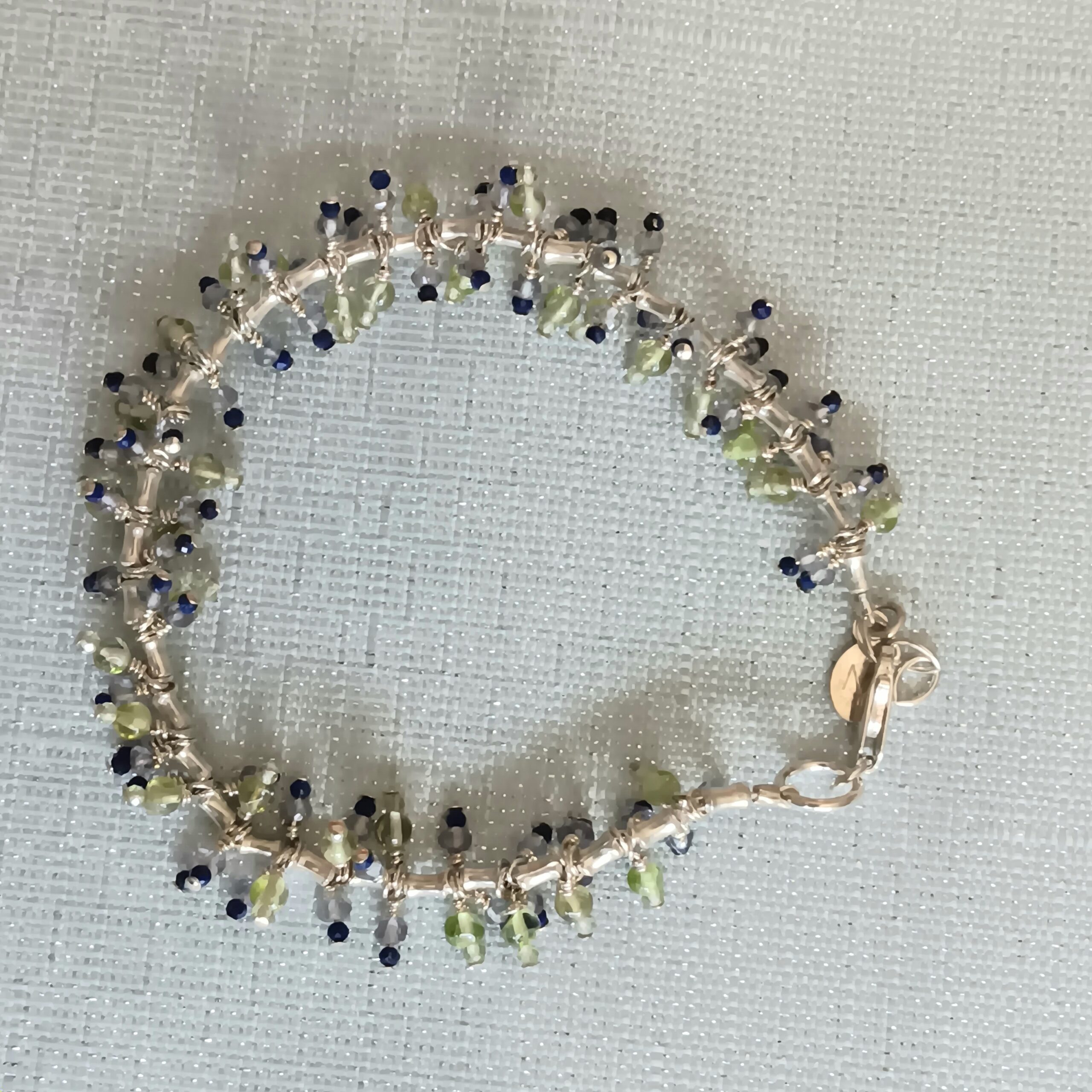Caterpillar bracelet w/ peridot and lapis