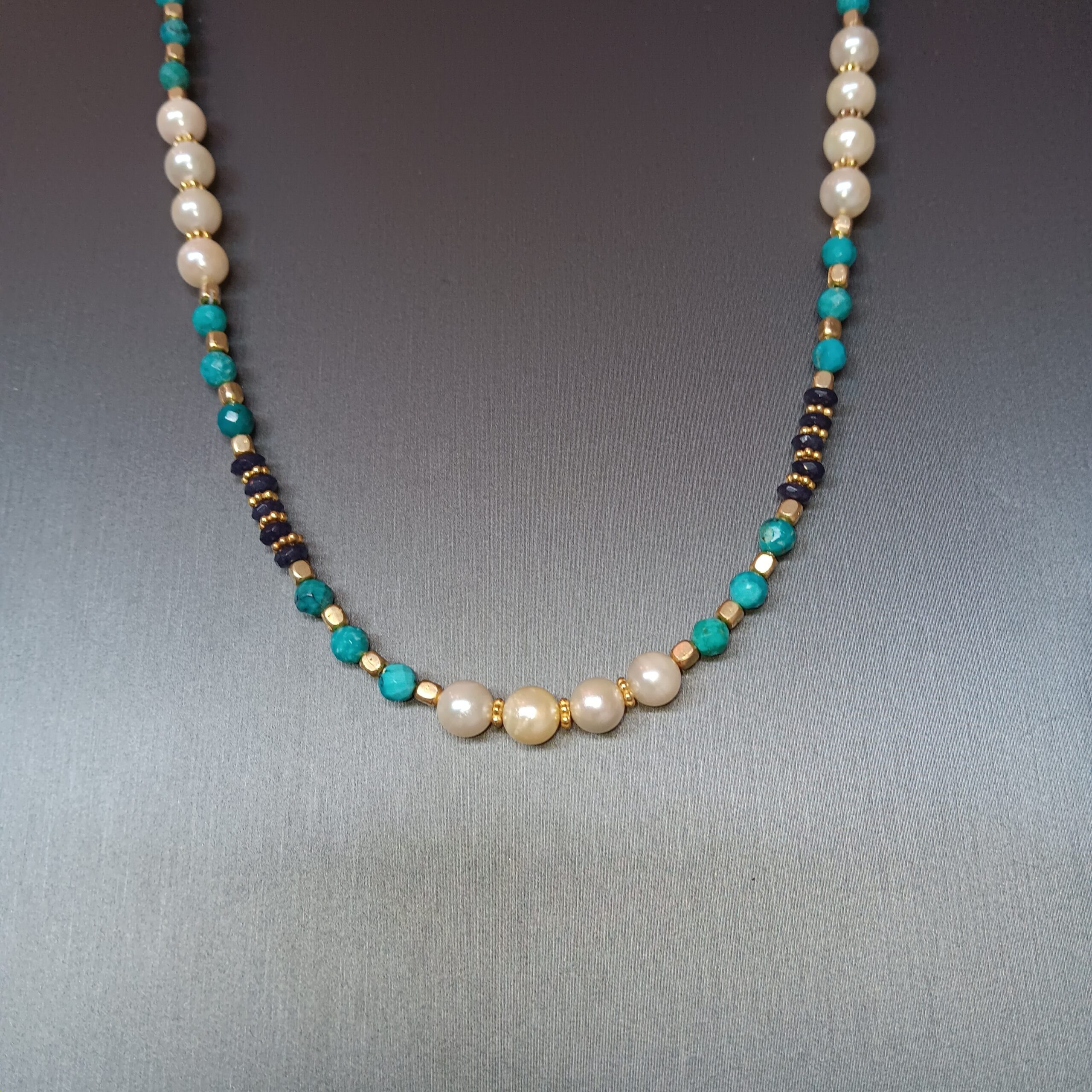 Pearls, turquoise, and sapphire beads. Gold plated components.